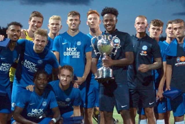 Posh skipper Jermaine Anderson and teammates with the Maunsell Cup. Photo: Peter Short.