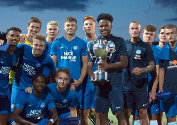 Posh skipper Jermaine Anderson and teammates with the Maunsell Cup. Photo: Peter Short.