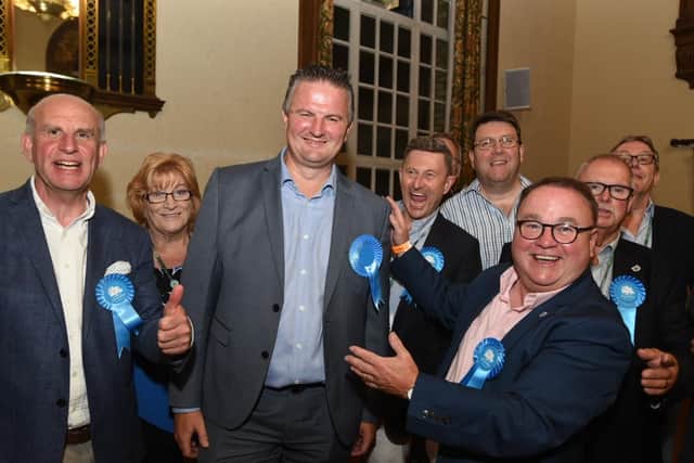 Gavin Elsey (front and centre) celebrates his win with fellow Conservatives