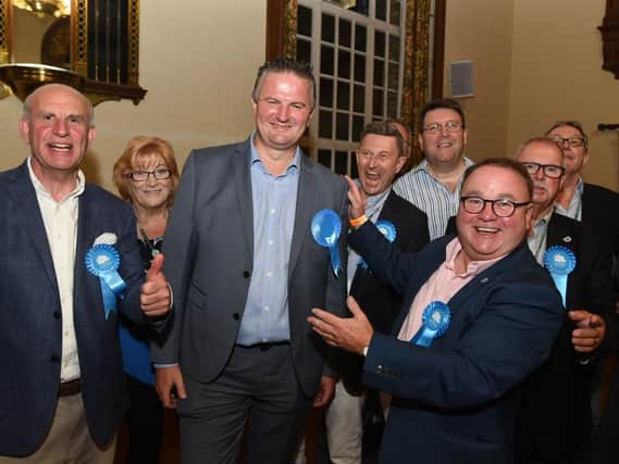 Gavin Elsey (front and centre) celebrates his win with fellow Conservatives