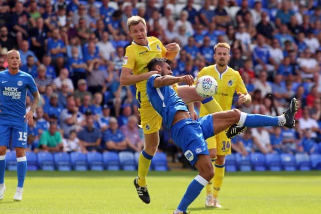 Posh centre-back Ryan Tafazolli under pressure from Bristol Rovers defender Tony Craig. Photo: Joe Dent/theposh.com..