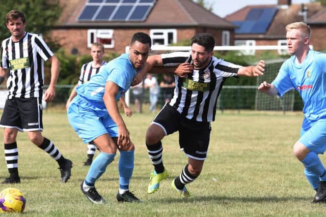 Zak Dunn (stripes) of Peterborough Northern Star in action against Rugby Town. Photo: Chantelle McDonald. @cmcdphotos.