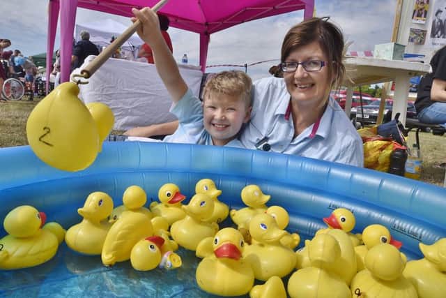 Friends of Itter Park fun day at Paston.  Dawn Hughes and Hayden Hughes (8) on the Werrington Brownies stall. EMN-180508-203309009
