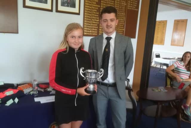 Emily Horsted received her Milton Junior Open prize from Richard Berry.