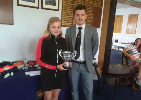 Emily Horsted received her Milton Junior Open prize from Richard Berry.