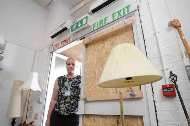 Kellie Preston, store manager at Sue Ryder at Eye, looking at the damage from the first theft EMN-180608-122130009