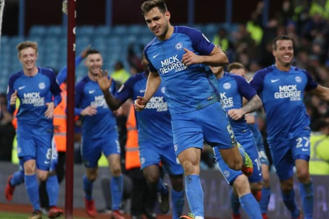 Ryan Tafazolli celebrates an FA Cup goal for Posh at Aston Villa last season.