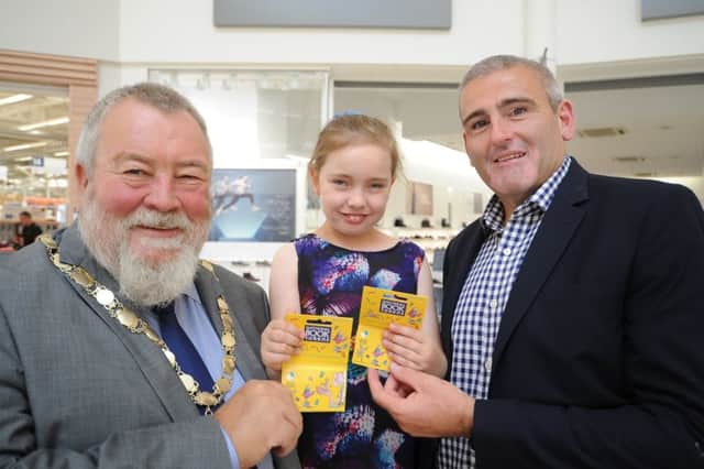 Deputy Mayor Coun. John Fox and Serpentine Green  centre manager David Wait with reading competition winner  Hannah Connor (9) EMN-180708-230118009