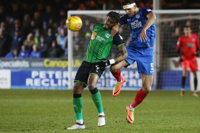 Ivan Toney (green) battles with Posh centre-back Ryan Tafazolli, while playing for Scunthorpe last season.
