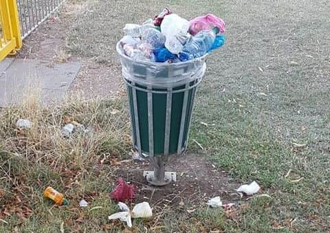An overflowing bin at the Old Fletton playground. Photo: Garry Roberts