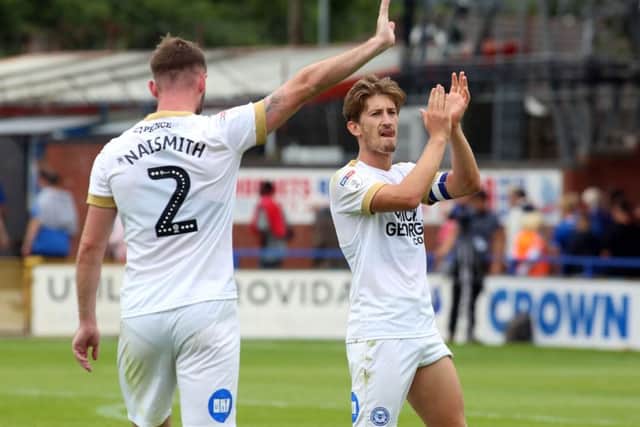 Posh skipper Alex Woodyard applauds the club's travelling fans after the final whistle at Rochdale. Photo: Joe Dent/theposh.com.