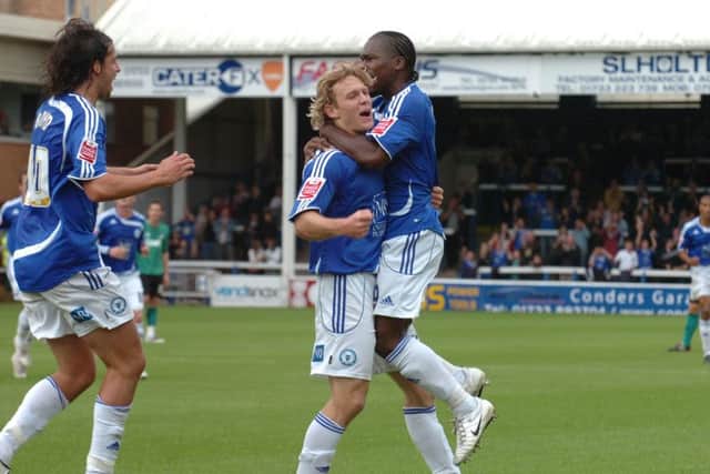 A star Posh strike force of Craig Mackail-Smith and Aaron Mclean celebrate a goal. George Boyd is also on the scene.