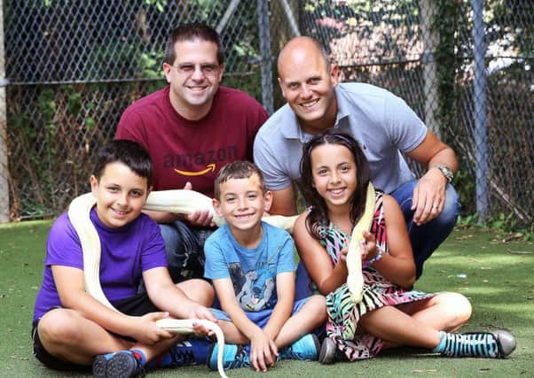 Eric Schultz   and Martin Cox  with children Romeo (8), Angel (9) and Reuben (5) and Fluffy the snake.