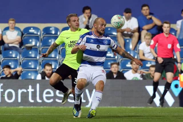 Jason Cummings of Peterborough United in action with Toni Leistner of Queens Park Rangers. Photo: Joe Dent/theposh.com.: