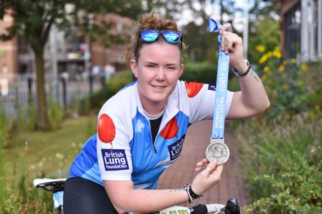 Sponsored cyclist Katie Barrett, assistant steward at the Peterborough Conservative Club who raised Â£700 for the British Lung Foundation and Shine riding 46 miles in the London Prudential Ride on Sunday (July 29th) finishing outside Buckingham Palace EMN-180731-131418009