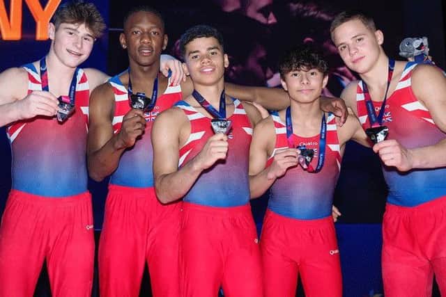 Jake Jarman (second right) celebrates winning a silver medal with his GB team-mates.