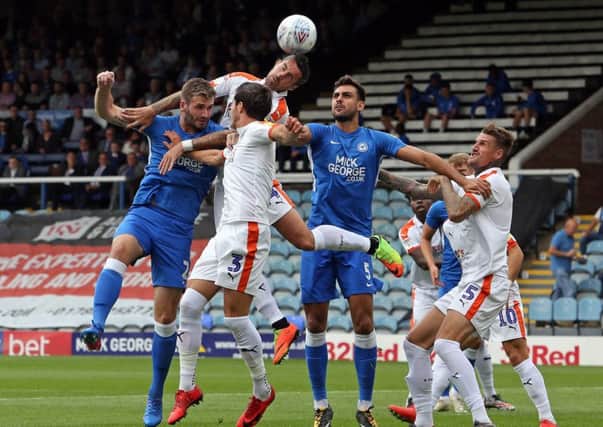 Posh defenders Jason Naismith (front) and Ryan Tafazolli compete for a high ball in the 3-1 win over Luton. Photo: Joe Dent/theposh.com.