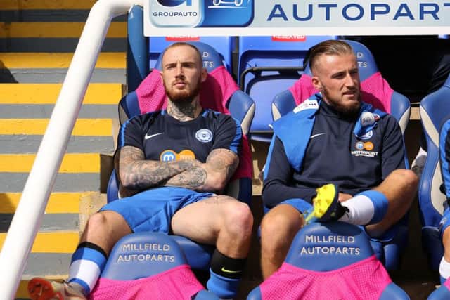 Marcus Maddison (left) was back on the substitutes' bench for Posh against Luton. Photo: Joe Dent/theposh.com.