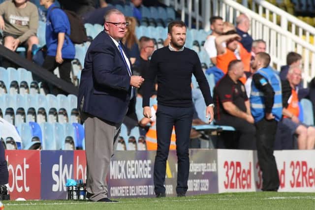 Rival managers Steve Evans (left) and Nathan Jones watch the action at the ABAX Stadium. Photo: Joe Dent/theposh.com.