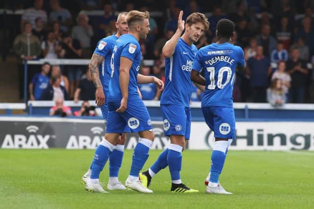 Siriki Dembele gets congratulations from skipper Alex Woodyard after his goal for Posh against Luton. Photo: Joe Dent/theposh.com.