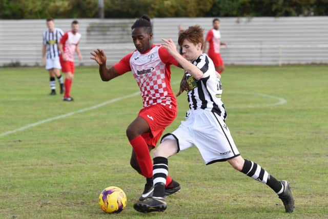 Jack Wilson of Peterborough Northern Star (stripes) in action in a 5-0 win at Rothwell Corinthians. Photo: Chantelle McDonald. @cmcdphotos.