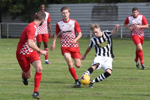 Lucas Gereltauskas (stripes) of Peterborough Northern Star scores to make it 1-0 at Rothwell Corinthians. Photo: Chantelle McDonald. @cmcdphotos.