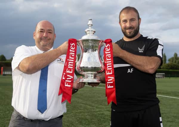 Yaxley chairman Malcolm Clements and manager Andy Furnell with the Emirates FA Cup. The trophy was at the club yesterday for photo opportunities. 
Photo: Alan Walter
