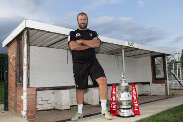 Yaxley manager Andy Furnell pictured with the Emirates FA Cup. The trophy was at In2itive Park yesterday for photo opportunties. Photo: Alan Walter