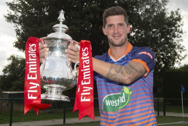 Yaxley captain Ross Watson  with the Emirates FA Cup. 
Photo: Alan Walter