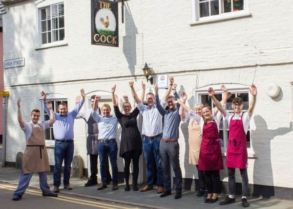 Staff at The Cock in Hemingford Grey celebrating winning the Good Pub Guide Pub of the Year award