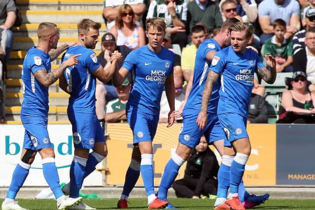 Matt Godden of Peterborough United celebrates scoring the opening goal at Plymouth with team-mates. Picture: Joe Dent