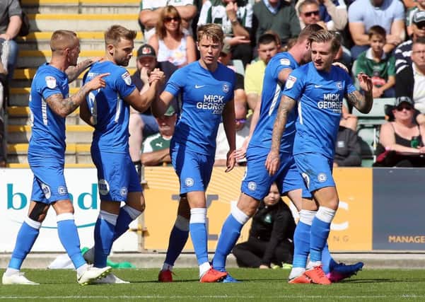 Matt Godden of Peterborough United celebrates scoring the opening goal at Plymouth with team-mates. Picture: Joe Dent