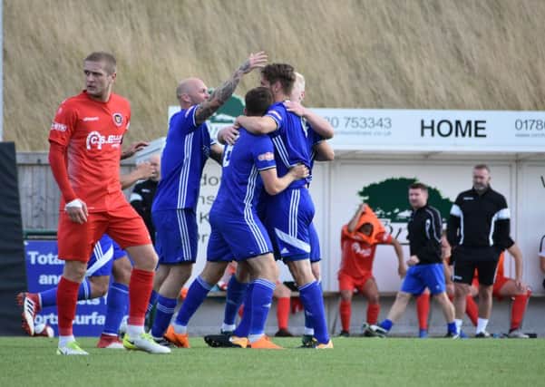 Stuart Wall is congratulated after heading the Peterborough Sports equaliser. Picture: James Richardson