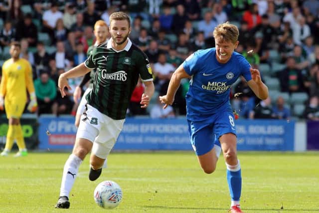 Mark O'Hara of Peterborough United in action with Jamie Ness of Plymouth Argyle. Picture: Joe Dent