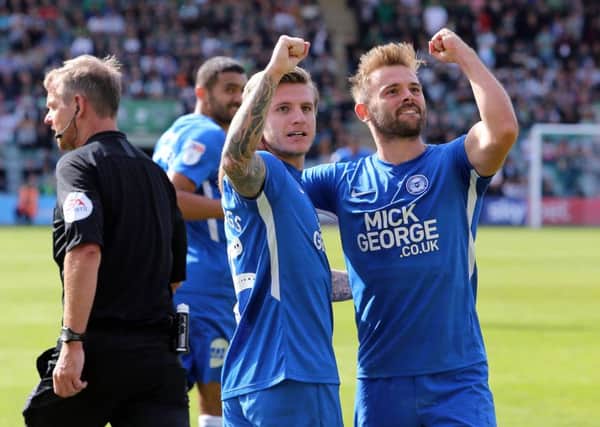 Jason Cummings of Peterborough United and team-mate Matt Godden celebrate the fourth goal at Plymouth. Picture: Joe Dent