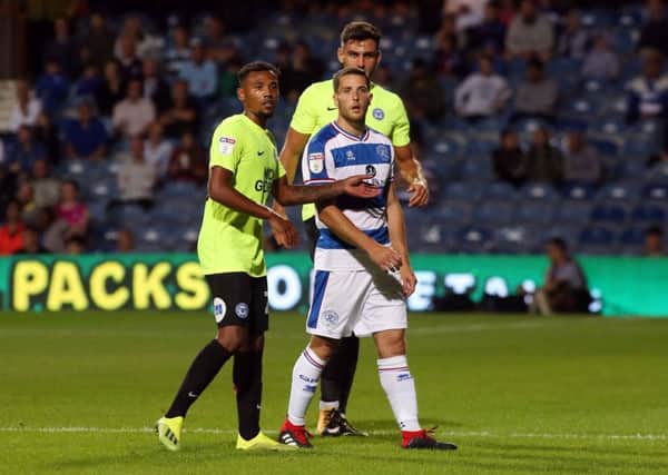 Conor Washington of QPR  is marked by Tyler Denton and Ryan Tafazolli of Peterborough United in a Carabao Cup match earlier this month. Picture: Joe Dent