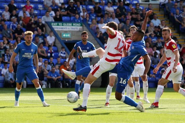 Rhys Bennett of Peterborough United challenges for the ball with Tom Anderson of Doncaster Rovers - Mandatory by-line: Joe Dent/JMP - 01/09/2018 - FOOTBALL - ABAX Stadium - Peterborough, England - Peterborough United v Doncaster Rovers - Sky Bet League One