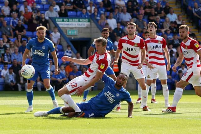Rhys Bennett of Peterborough United challenges for the ball with Tom Anderson of Doncaster Rovers - Mandatory by-line: Joe Dent/JMP - 01/09/2018 - FOOTBALL - ABAX Stadium - Peterborough, England - Peterborough United v Doncaster Rovers - Sky Bet League One