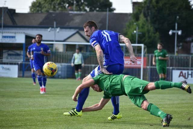 Two-goal Josh Moreman (blue) in action for Peterborough Sports against Kidlington. Photo: James Richardson.