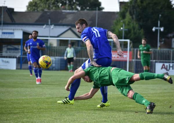 Two-goal Josh Moreman (blue) in action for Peterborough Sports against Kidlington. Photo: James Richardson.
