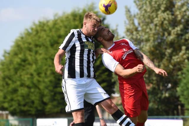 Jake Sansby (stripes) of Peterborough Northern Star in action against Fakenham Town. Photo: Chantelle McDonald. @cmcdphotos.