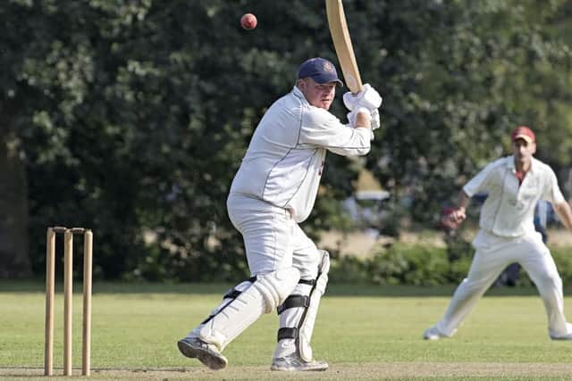Gary Frrear hits out during his innings of 131 not out for Wisbech against March. Photo: Pat Ringham.
