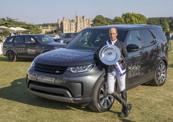 New Zealand's Tim Price poses with his trophy on a Land Rover Discovery after winning the Land Rover Burghley Horse Trials in Stamford, Lincolnshire, riding Ringwood Sky Boy. Picture: Steve Parsons/PA Wire