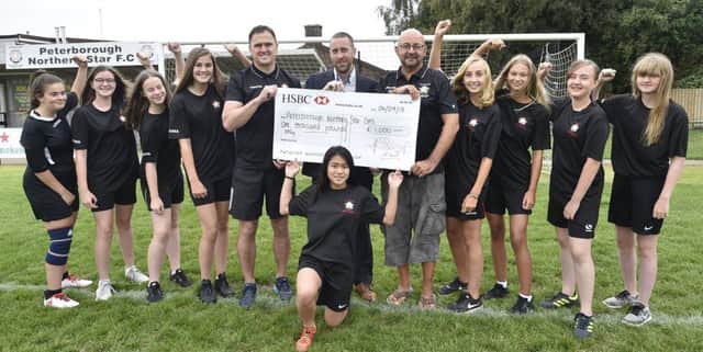 Vince Smith (manager) and John Bell (assistant manager) with Sean Feeley, marketing manager for Mick George Ltd with  some of the Peterborough Northern Star U15's  girls team who have received Â£1,000  sponsorship  from Mick George. EMN-180409-140602009