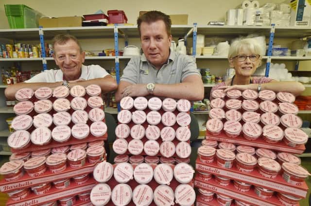 John Freeman and Elaine Stapleford, volunteers at the Peterborough Soup Kitchen at Rock Road, receive the pots of protein pudding from Bill Wilson from Muscle Finesse at Orton Southgate. EMN-180309-131400009