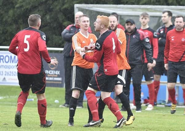 Adam Scott (orange, centre) misses Thorney's game with Moulton Harrox.