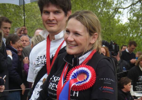 Claire Lomas and her husband Dan Spincer after crossing the finish line of the London Marathon 2012.  ENGEMN00120120905095848