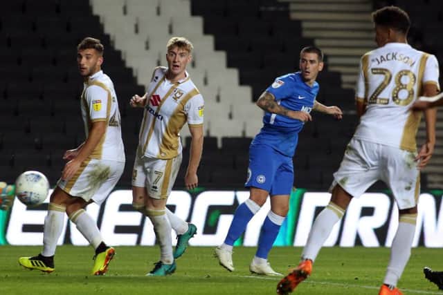 Jamie Walker watches his shot hit the back of the net for Posh against MK Dons. Photo: Joe Dent/theposh.com.