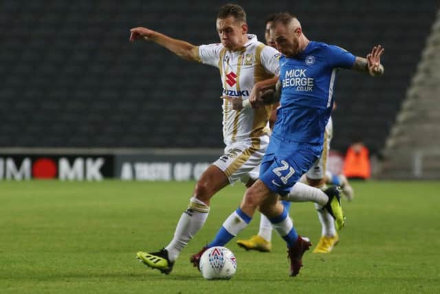 Marcus Maddison in action for Posh at MK Dons.