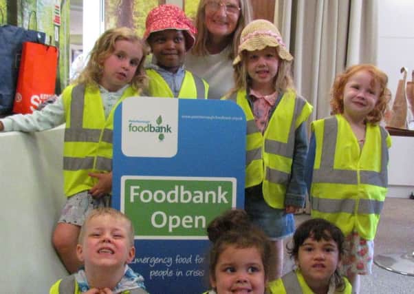 Jan Martin with the children from The Hampton Day Nursery at the local Food Bank
